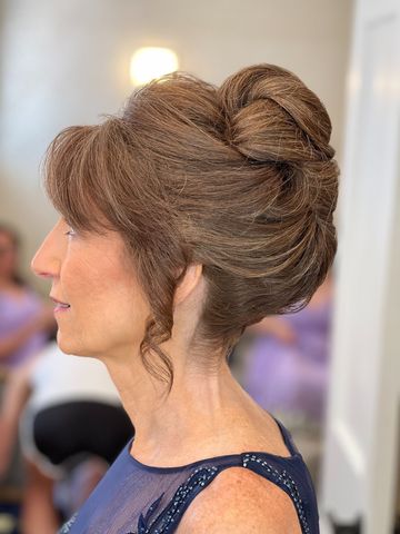 Mother of the bride with an elegant French-twist updo on the wedding morning